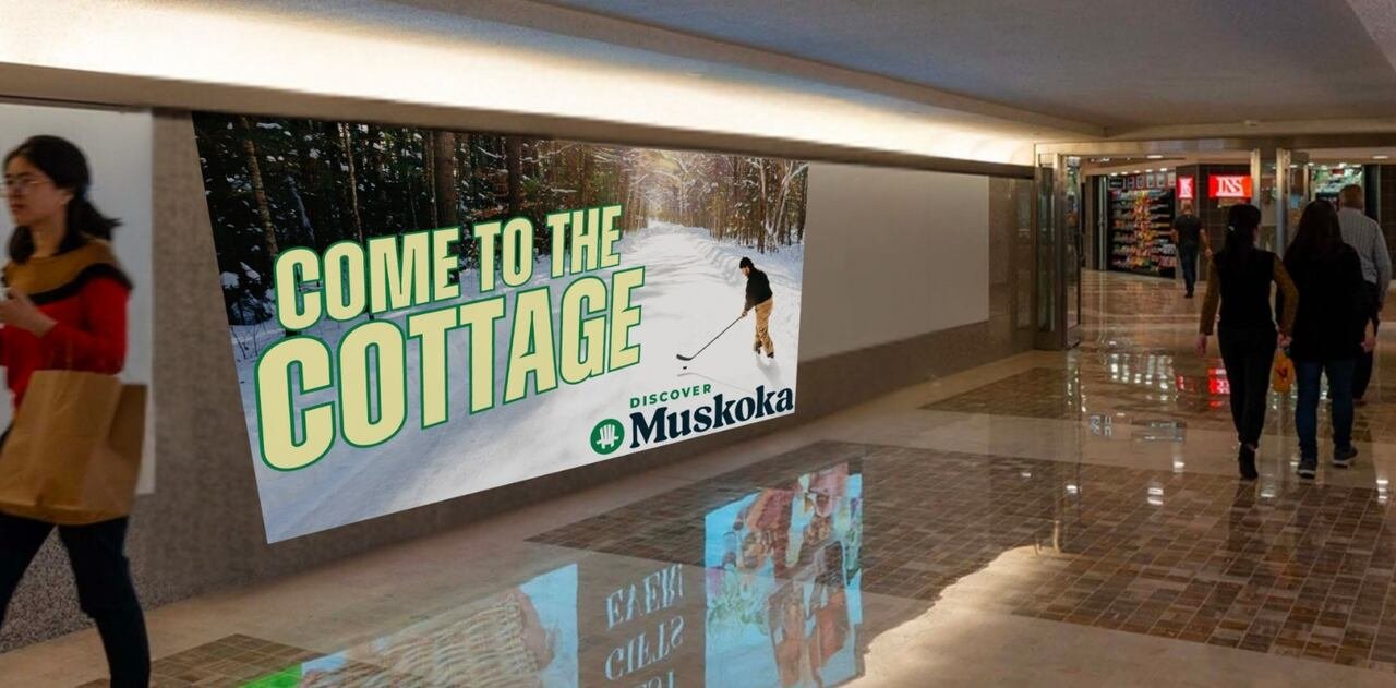 default-170 A billboard that says come to the cottage and shows a person playing hockey on a frozen lake