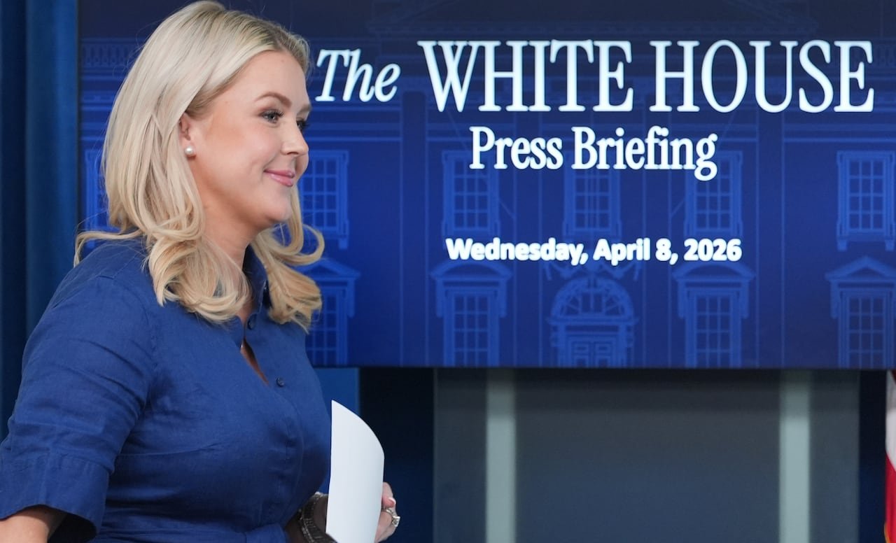 Karoline Leavitt, seen in profile in front of a monitor that says 'The White House Press Briefing, Wednesday, April 8, 2026'