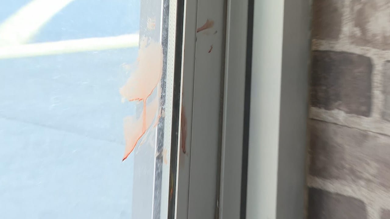 default-145 Bloodstains on a store's entrance door frame, remaining days after the attack.